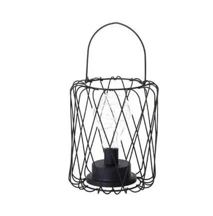 Minimalist hollow iron table lamp with warm white light on a wooden desk