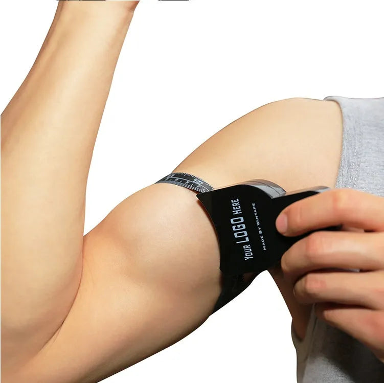 Black ABS body fat caliper instrument with measurement scale and pinching mechanism.