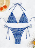 Women's green split bandage bikini with printed stitching on a mannequin.