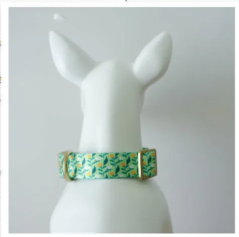 Flower patterned nylon pet collar with metal buckle, shown in Hanada colour on a size chart.