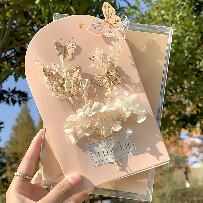 Handmade 3D butterfly-shaped birthday card with artificial flowers, shown with its matching envelope.