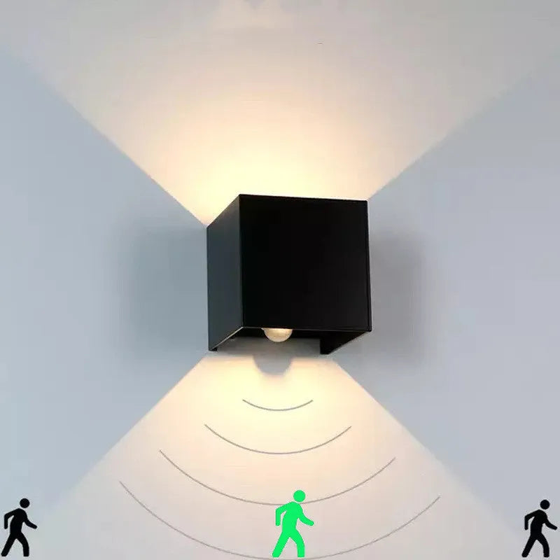 Square black aluminium alloy wall lamp mounted on a corridor wall