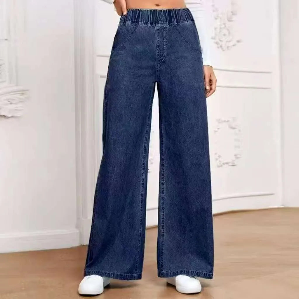Light blue washed wide-leg straight denim trousers on a hanger, showing mid waist and zip fly.