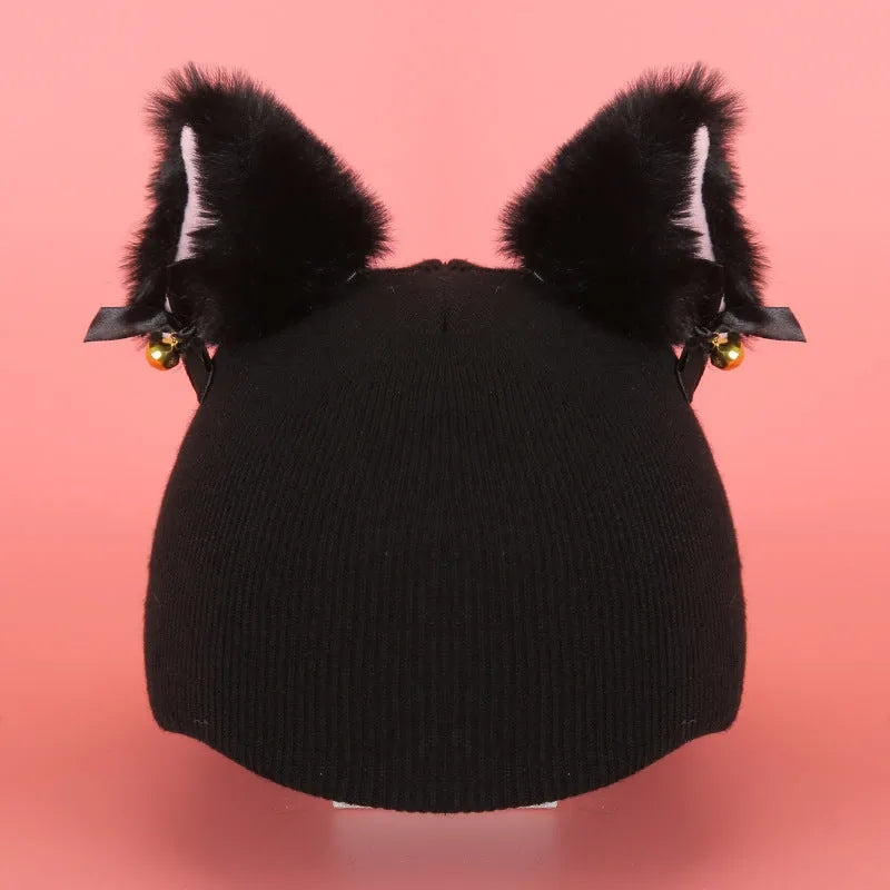 Colourful plush cartoon hat decoration sitting on top of a ski helmet