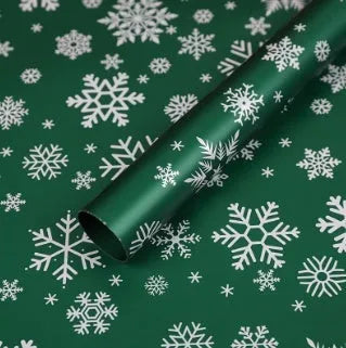 Christmas Kraft paper gift wrap sheets with red and green ink printed cartoon designs including polka dots, snowflakes, and Christmas trees