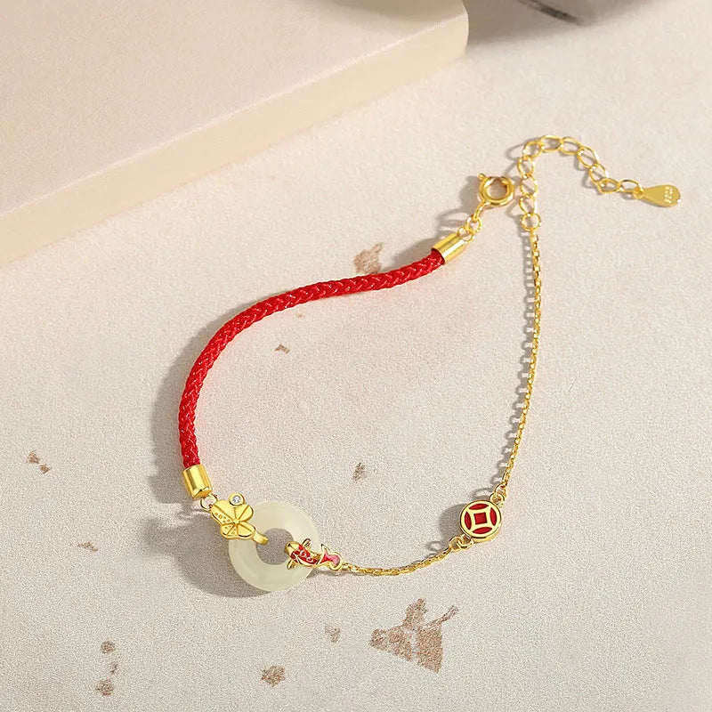 Gold koi peace buckle bracelet made from 925 silver with red rope closure
