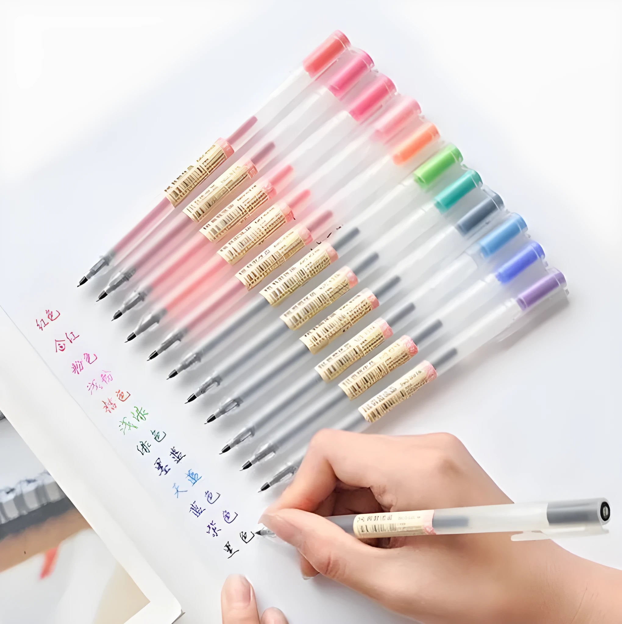 Set of twelve black Muji gel pens with 0.5mm fine nibs, showing anti-leak mechanism and aqueous ink.