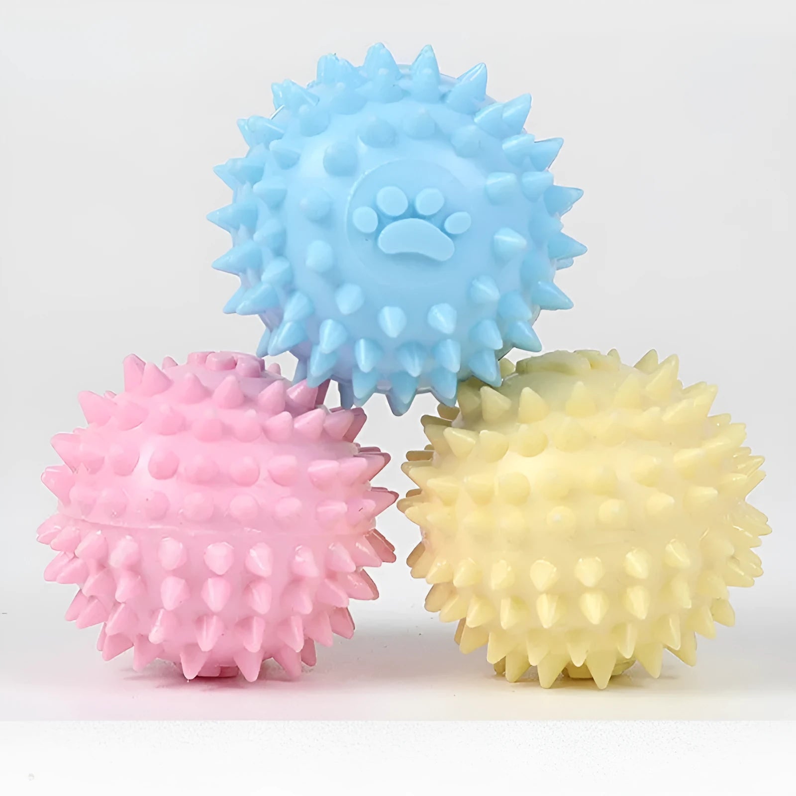 6cm TPR dog chewing ball with textured footprint surface in blue, pink and yellow colour options