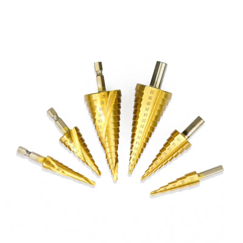 High-speed steel step drill bits and a centre punch set on a workbench, showing colour-coded tools.