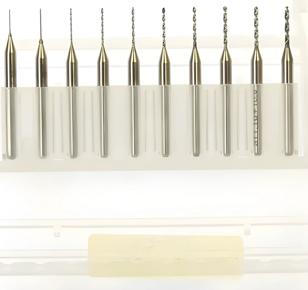 Close-up of a set of fine tungsten steel micro-engraving bits with diameters from 0.10mm to 2.00mm on a grey background.