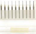 Close-up of a set of fine tungsten steel micro-engraving bits with diameters from 0.10mm to 2.00mm on a grey background.