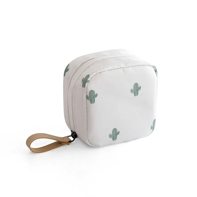 A blue cloth cube-shaped makeup storage bag with a plain pattern, shown closed.