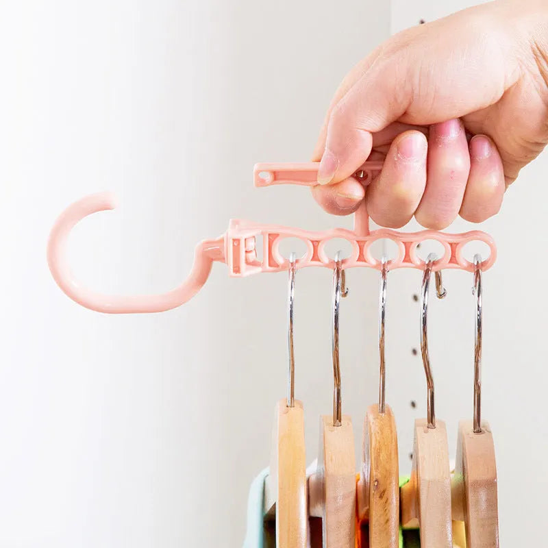 Blue revolving wardrobe hanger with five rotating branches and a central handle