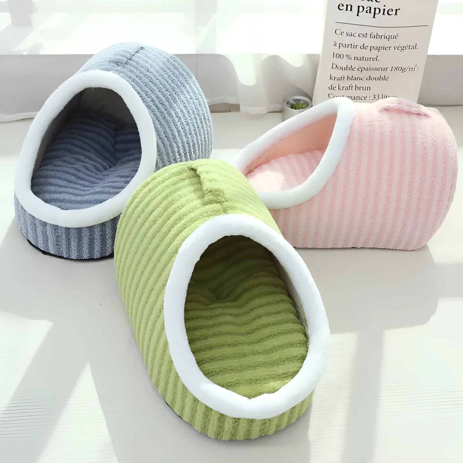 Macaron-shaped cat bed in blue colour, showing three-dimensional design with cloth material
