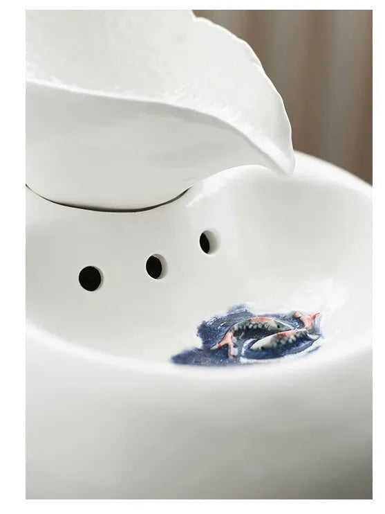 White porcelain leaf-shaped automatic cat water dispenser on floor