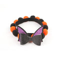 Halloween pet fur ball collar in pumpkin design with adjustable sizing