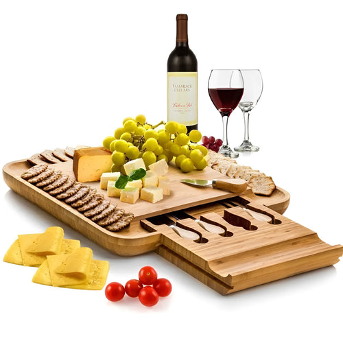 Square bamboo cutting board with drawer holding four-piece knife and fork set in wood colour