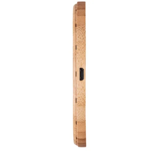 Natural bamboo wireless charger pad on desk with a smartphone placed on it