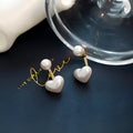 Heart-shaped alloy stud earrings with electroplated finish and inlaid artificial stones.