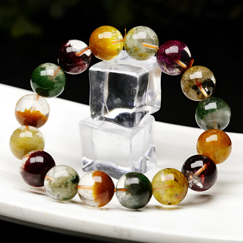 Colourful ghost cornucopia crystal bracelet with 10mm beads on a wrist.