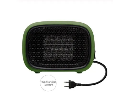 Compact green mini ceramic desk heater with metal mesh front grille, shown next to a pen for scale.