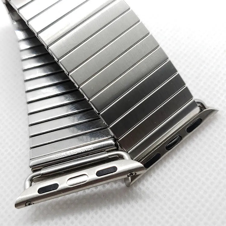 Silver stainless steel elastic Apple Watch band on a wrist, compatible with 38mm to 44mm cases