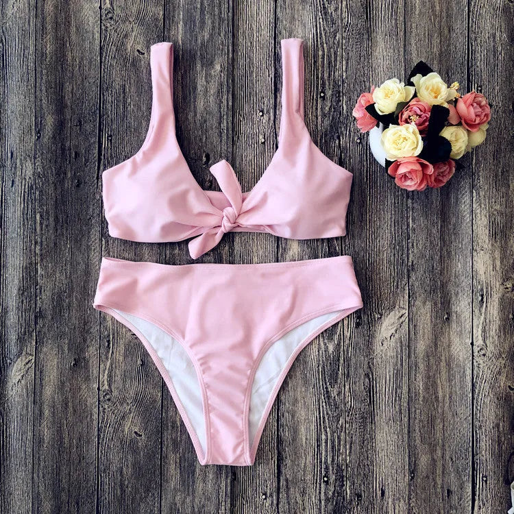 Women's solid colour bikini set showing bra top and briefs in black, pink, red, white, or wine red.