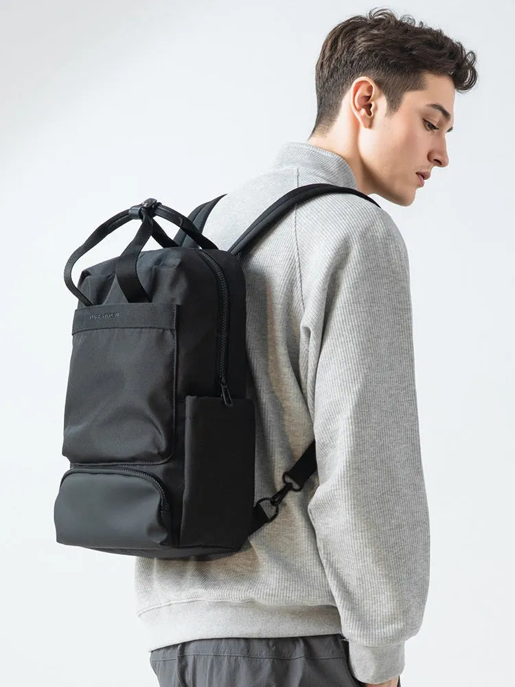 Black Oxford cloth computer backpack showing organisational storage compartments and laptop section