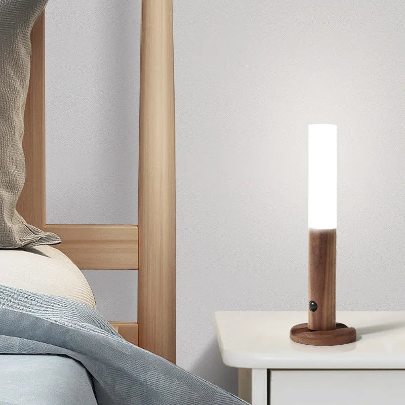 Wooden smart sensor LED desk lamp on a desk, showing compact size and simple design.
