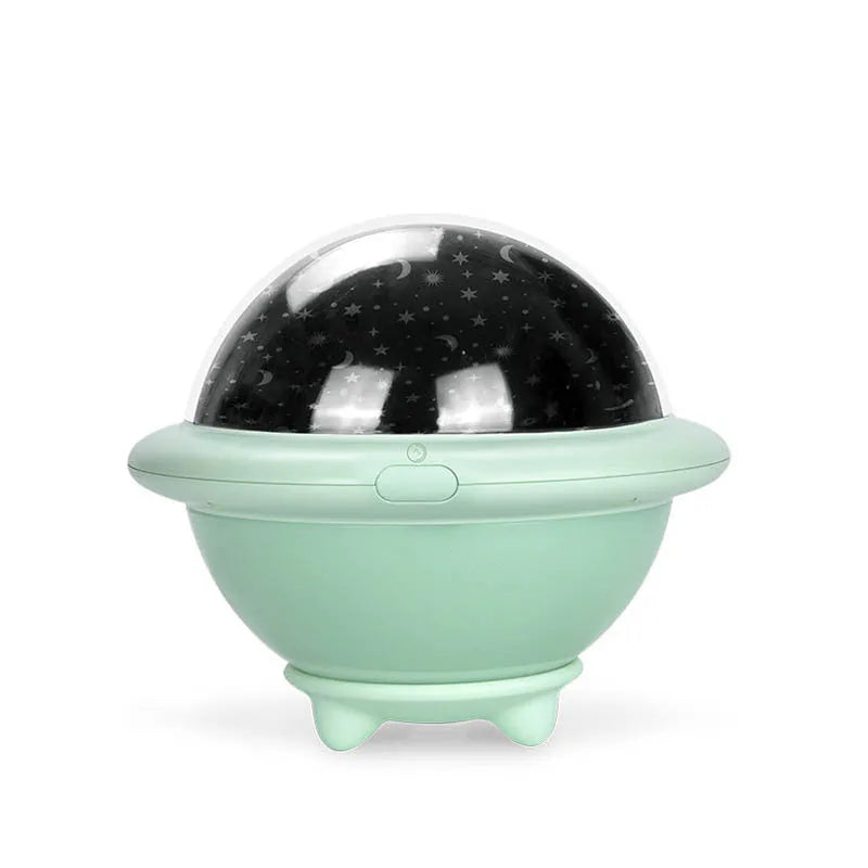 Green UFO-shaped plastic LED night light projecting a starry sky pattern, shown with a USB cable.