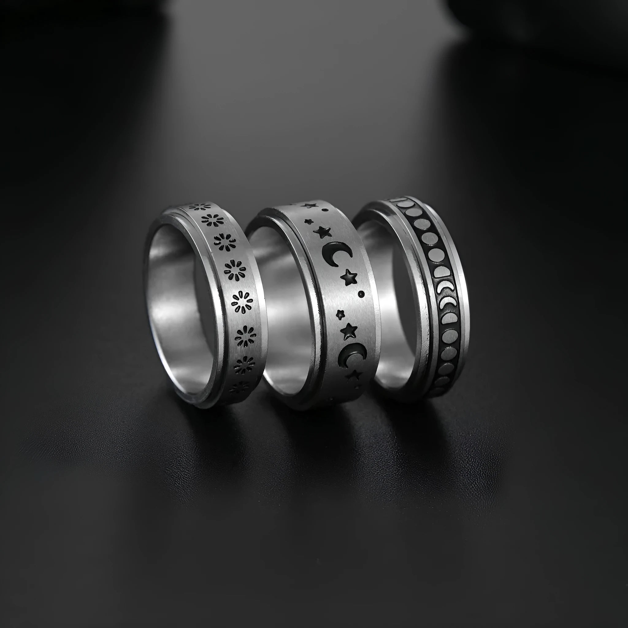 Titanium steel star moon ring in glossy finish on a neutral background, showing celestial motif and band width