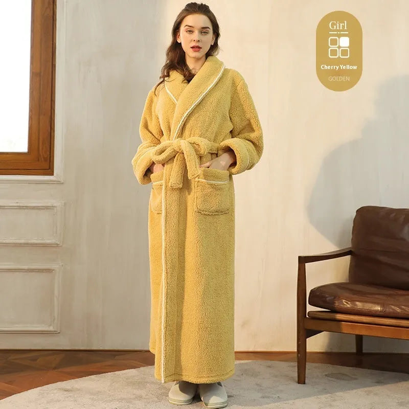 A man and woman wearing matching navy blue thick flannel bathrobes, showcasing the wrap-around design and plush fabric.