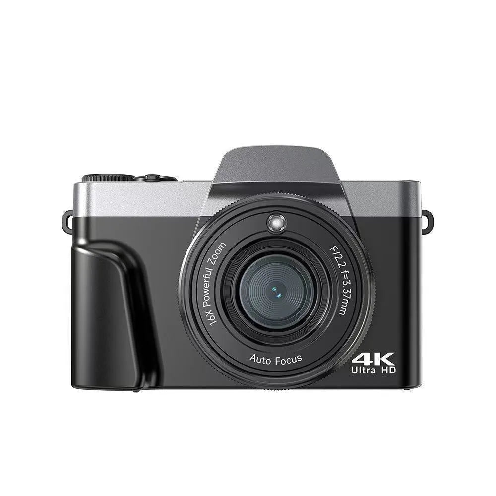 Black flip mirrorless digital camera resting on a cloth surface, showing its compact body and flip screen