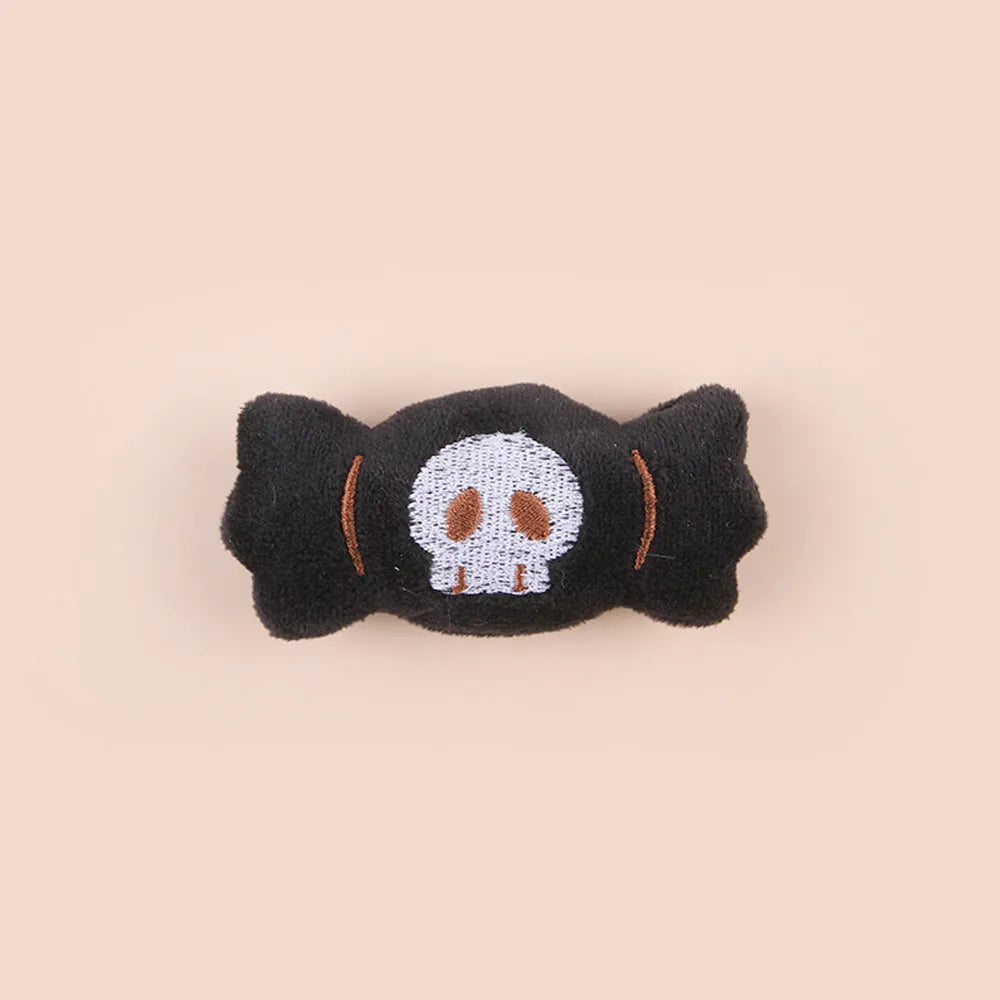 Small colourful plush cat teaser wand with candy, eyes, and skull designs