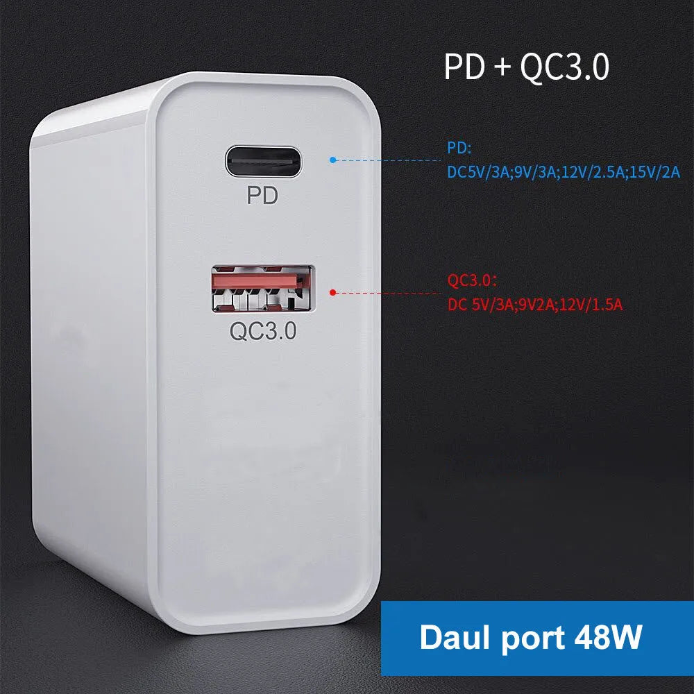 A white or black multi-port USB fast charger with PD and QC ports on a table.