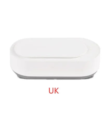 White portable ultrasonic cleaner with stainless steel tank and a single control button.