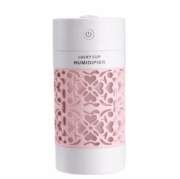 Lucky desktop humidifier 250ml USB powered in black with blue water bottle showing mist output on office desk