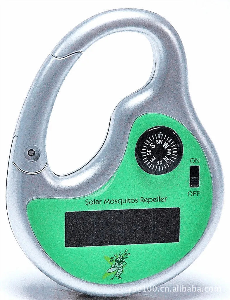 Green portable solar ultrasonic mosquito repellent on grass with sunlight charging