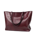 Brown waxed cowhide leather crossbody handbag showing front view with two compartments.
