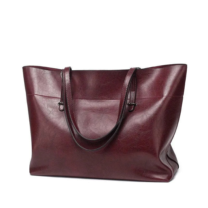 Brown waxed cowhide leather crossbody handbag showing front view with two compartments.