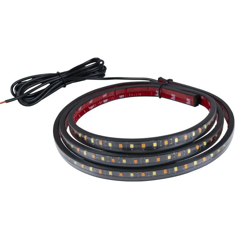 Pair of yellow pedal streamer side light lamps in flexible PVC casing on a dark background