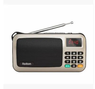 Golden Rolton W405 portable FM radio and MP3 speaker with LED display on a textured surface.