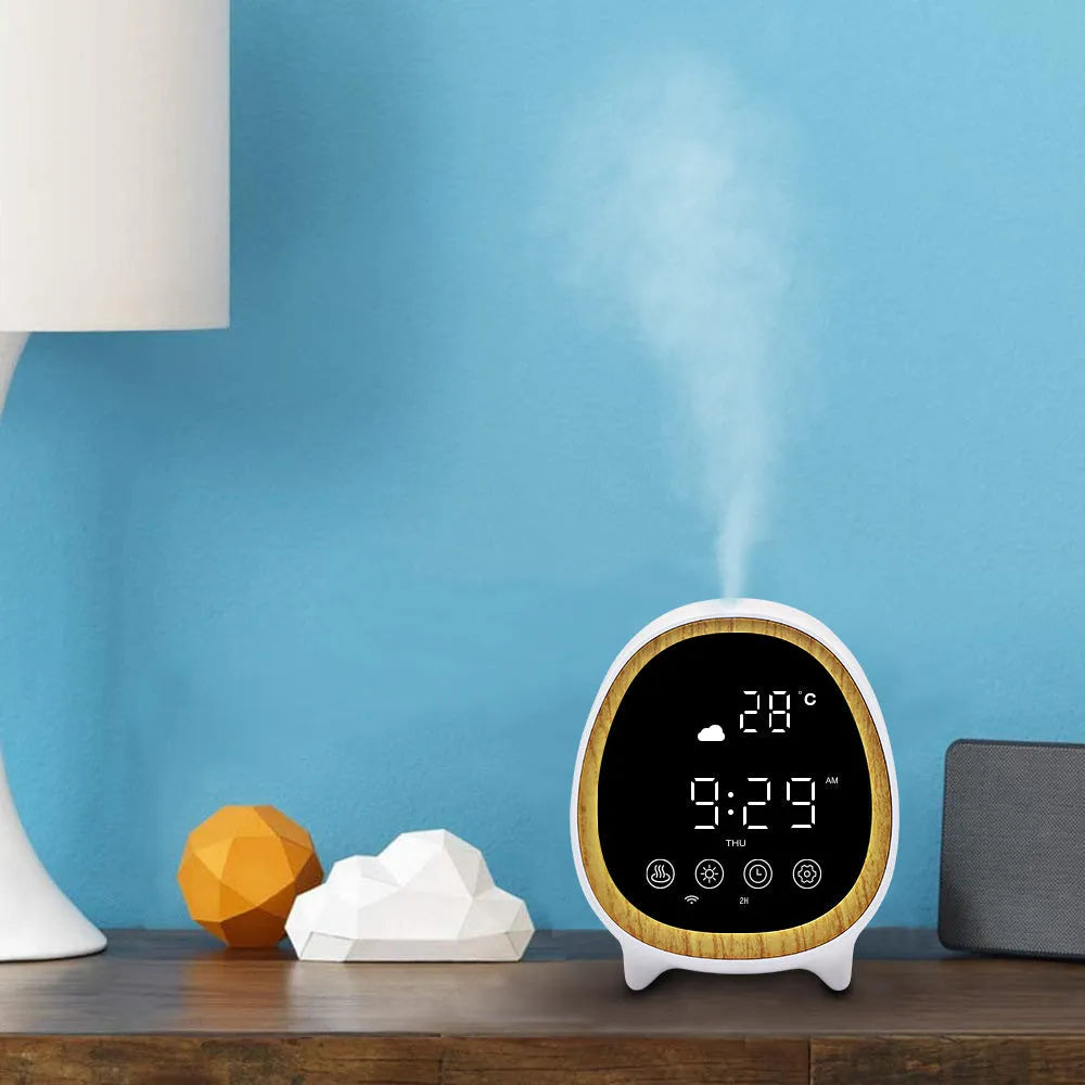 Round black smart WiFi aroma diffuser on a table with a fine cool mist rising from its top