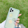 Green TPU iPhone case with geometric smiley face design and polka dot frame.