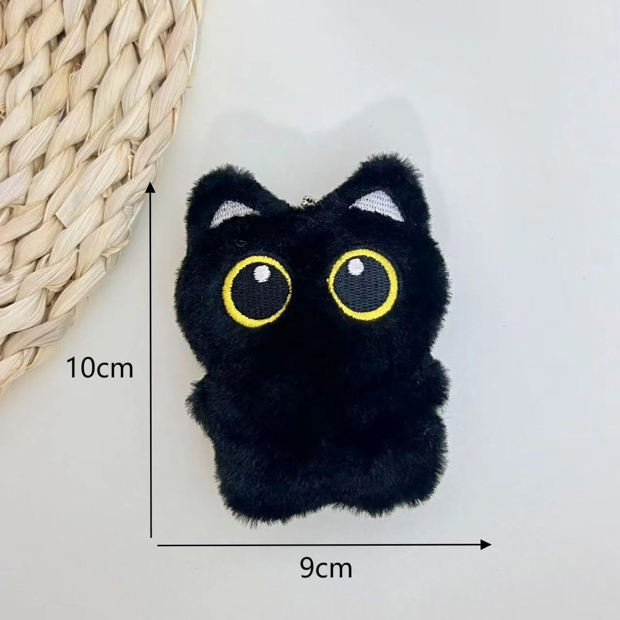 Cartoon big eye black cat doll plush with bead necklace as key decoration on a bag