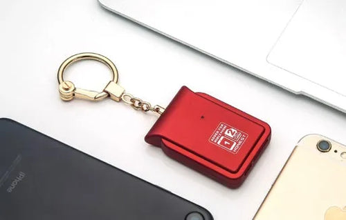 Bluetooth dual SIM adapter keychain for iOS with Nano SIM slot and Micro USB port.