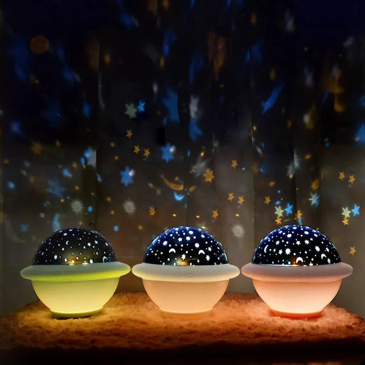 Green UFO-shaped plastic LED night light projecting a starry sky pattern, shown with a USB cable.