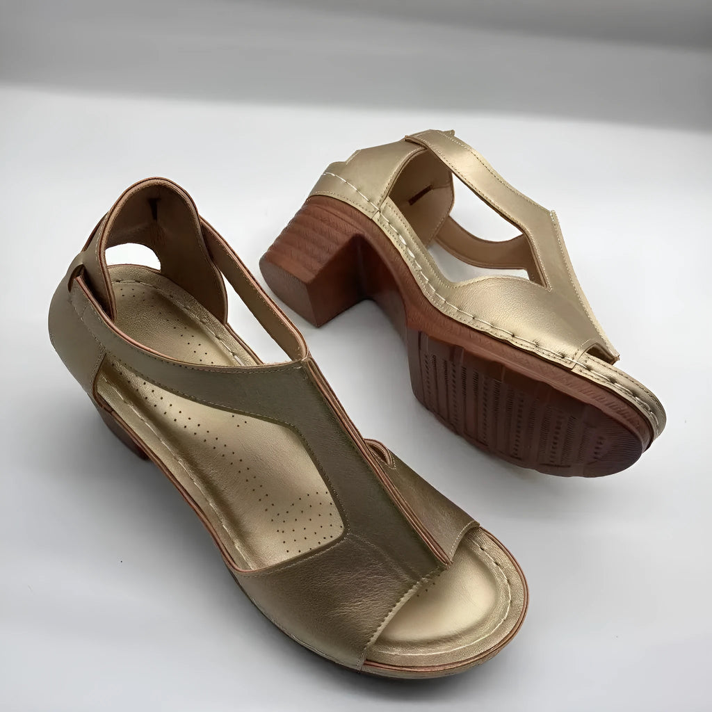 Women's white peep toe wedge sandals with a buckle strap on a slingback heel.