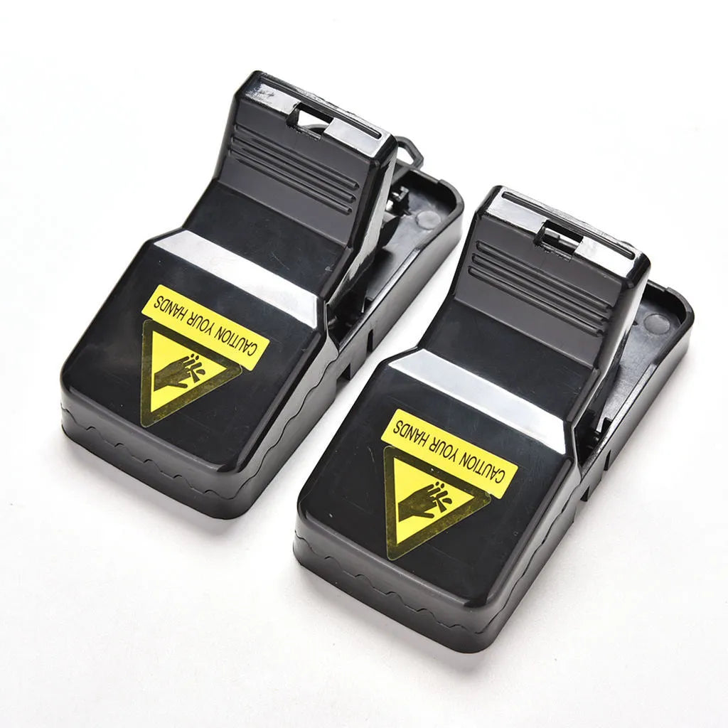 Six black plastic snapping mousetraps with metal trigger, shown on a white background.