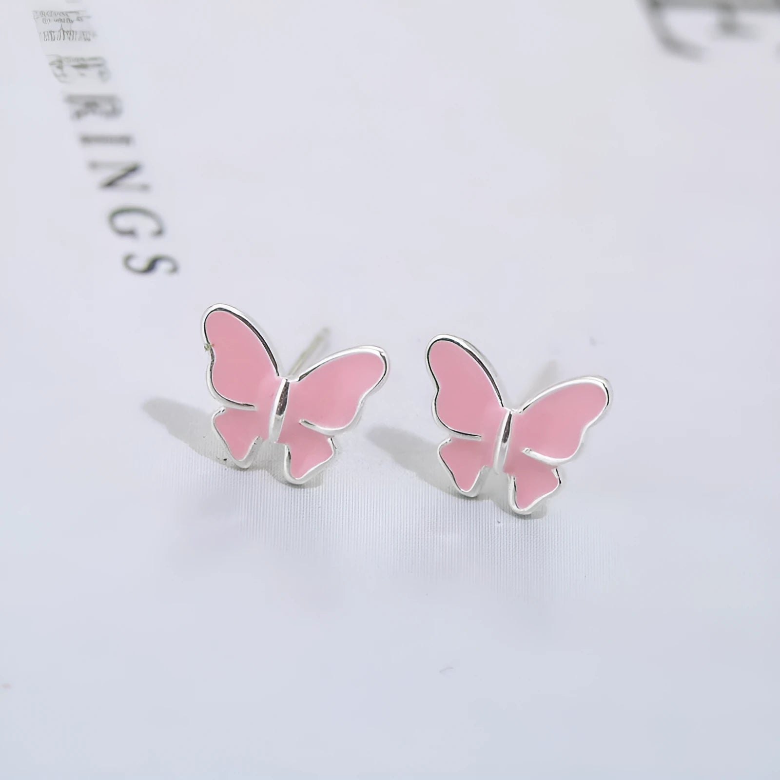 Side view of 925 silver butterfly stud earrings with geometric shape and plating finish